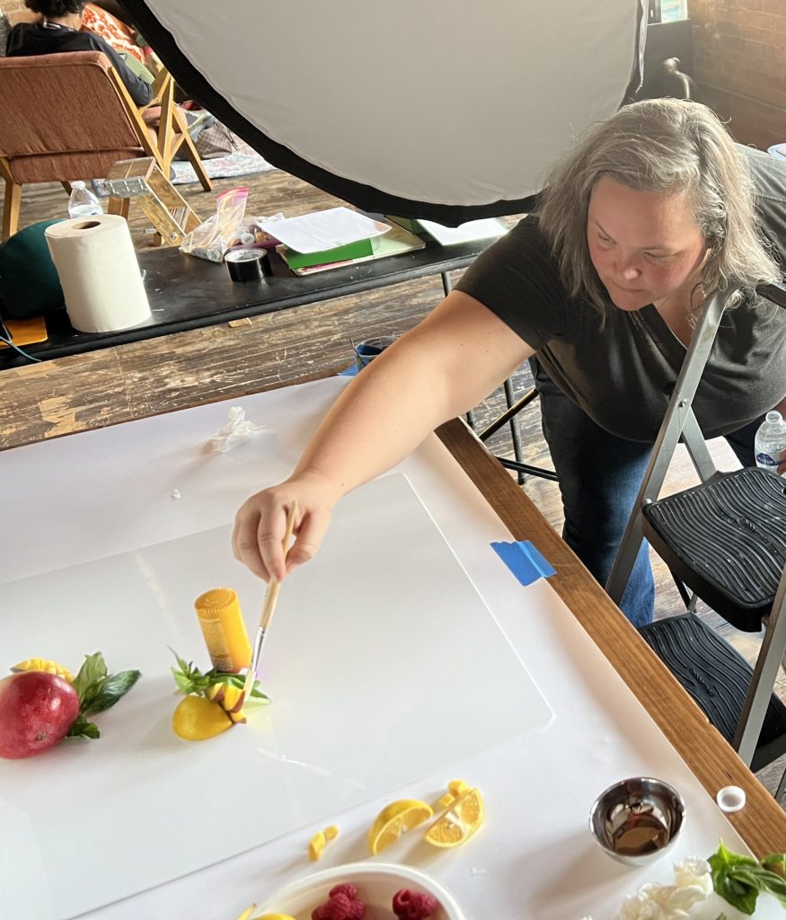 Krissy adjusting fruit on photo shoot - Jackson's Sweet Potato Chips Press Check - Seedhouse News